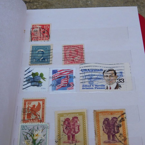 Red album with worldwide collectible stamps