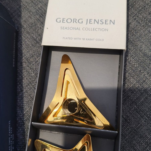 Georg Jensen gold-plated star candle holders with candles