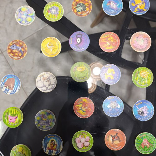 Pokemon Tazos used with visible wear