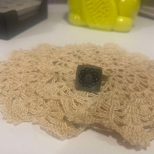 Metal ring used with adjustable green ceramic flower