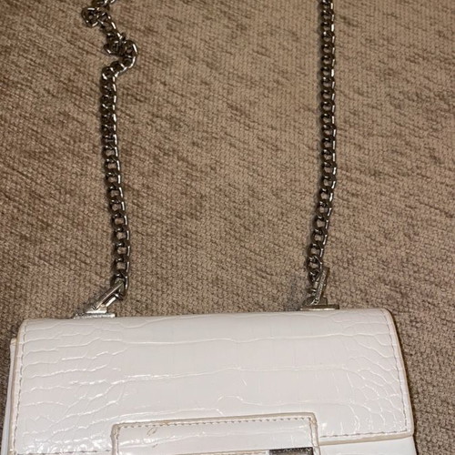 White crossbody bag used with silver details