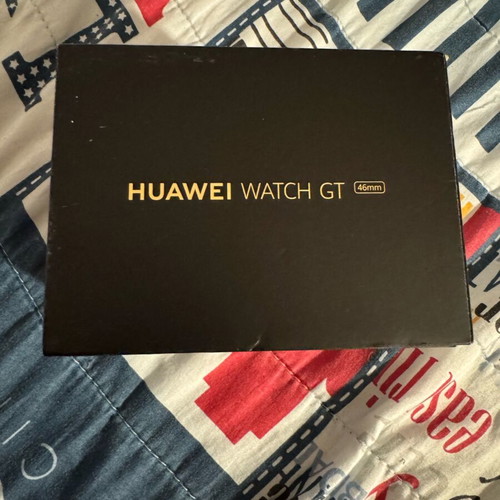 Huawei GT smartwatch used with charging base and fabric straps