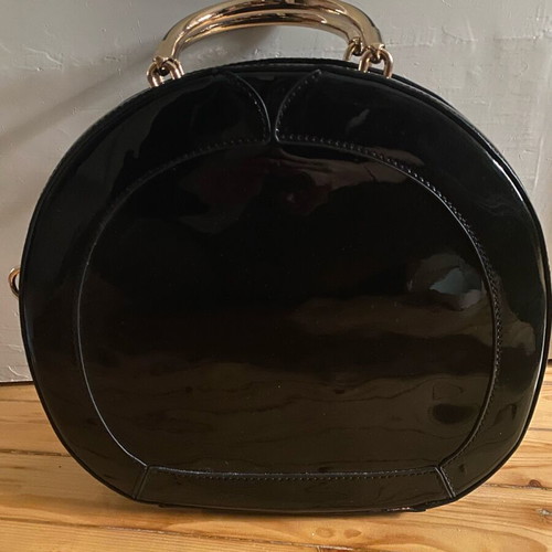 Round black glossy handbag like new with gold handles