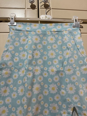 Mini skirt with daisies on blue background, size S, like new