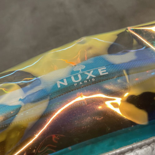 Nuxe holographic makeup bag with silver base