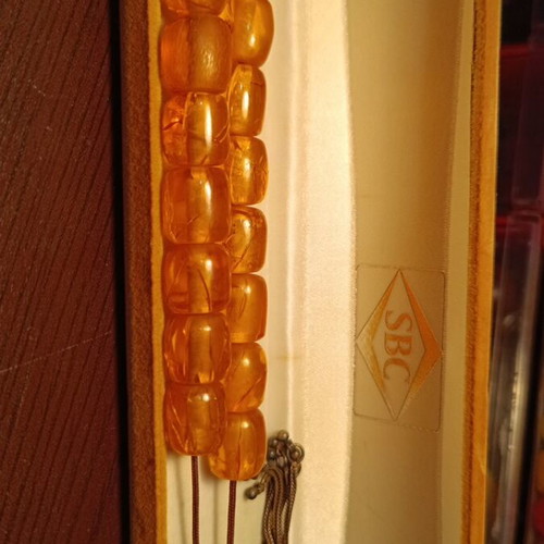 Handmade komboloi with amber-colored incense beads and silver finish, new