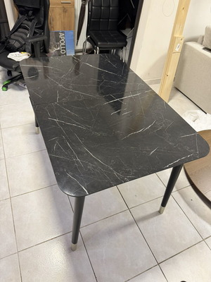 Dining table with black granite top and automatic extension used