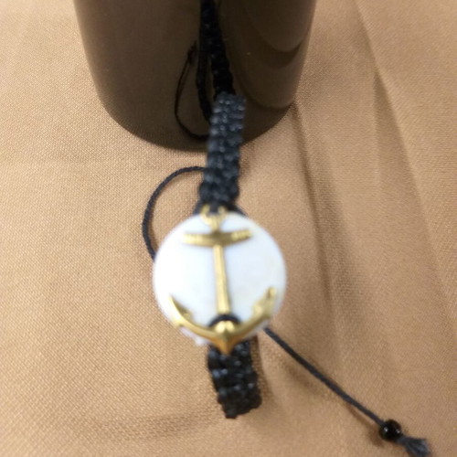 Macrame bracelet with gold anchor on white base