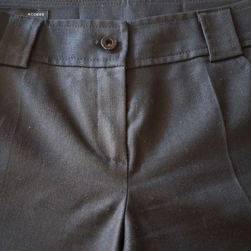 Access black pants like new with details on back pockets