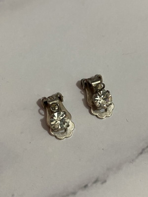 Clip-on earrings with rhinestones used, silver color