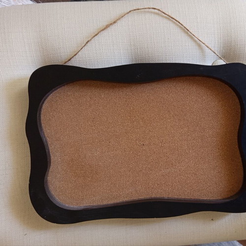 Retro cork board with wavy black wooden frame