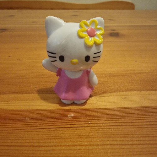 Hello Kitty figure used with pink dress and yellow flower