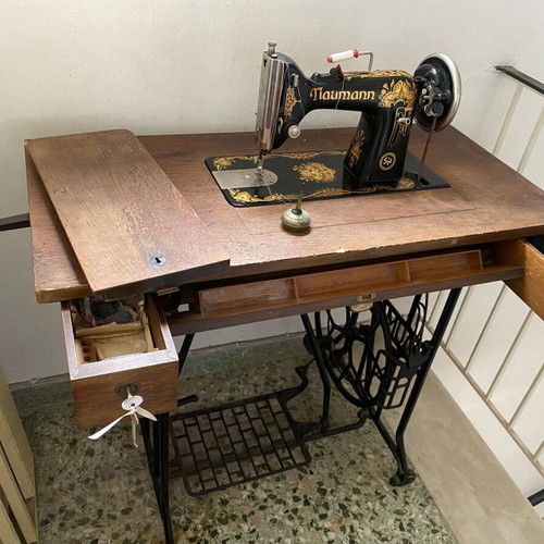 Naumann sewing machine used with cabinet and wheel