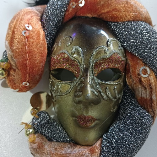 Decorative wall mask used, orange and silver shades