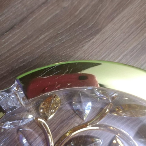 Crystal ashtray used, heavy with embossed gold-plated designs