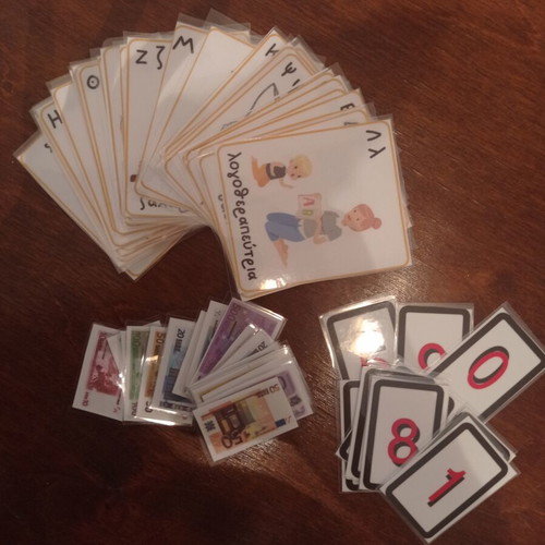 Educational laminated cards with alphabet, money, and numbers