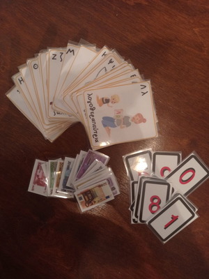 Educational laminated cards with alphabet, money, and numbers