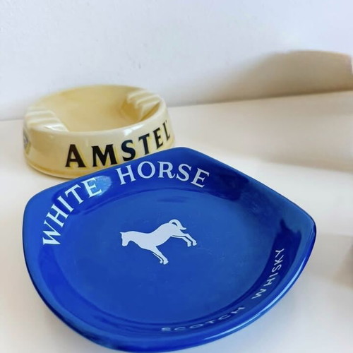 Set of 2 collectible porcelain ashtrays, Amstel and White Horse