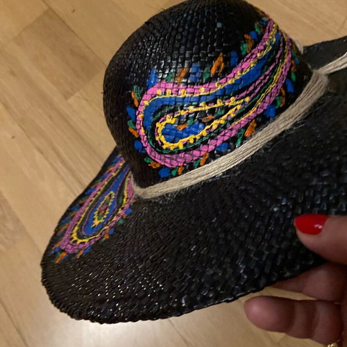 Painted hat on black background new for distinctive ladies