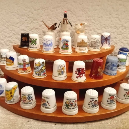 Porcelain thimbles like new, set of 33 with wooden base