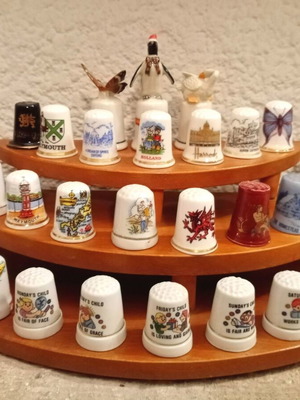 Porcelain thimbles like new, set of 33 with wooden base