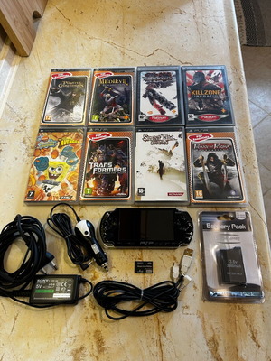 Sony PSP-2004 console with 8 game cartridges and accessories set