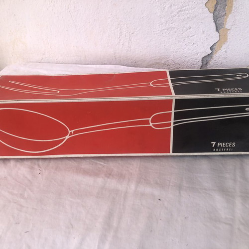 Vintage stainless steel kitchen tool set with black handles and wall rack