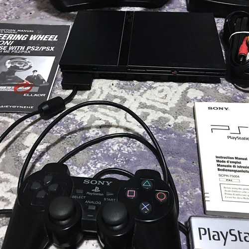 Playstation 2 Slim like new with steering wheel and 3 games