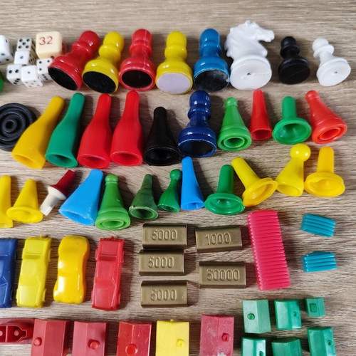 Lot of used board game parts including pawns, dice, cards, and hourglasses