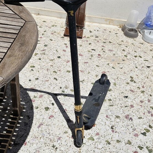 Root Industries Invictus Gold Rush freestyle scooter used with helmet and pads