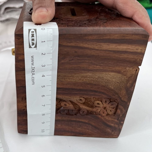 Wooden coin box with brass clip and carved design