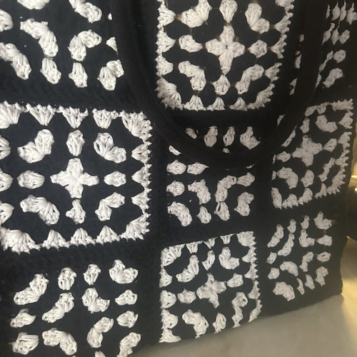 Handmade jute bag with black and white crochet motifs