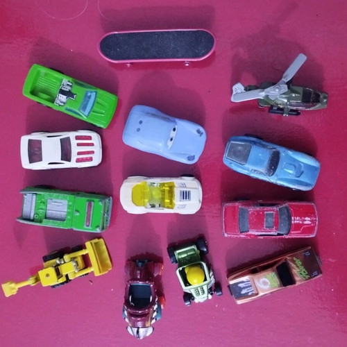 Set of various toy cars used, including helicopters and bulldozer