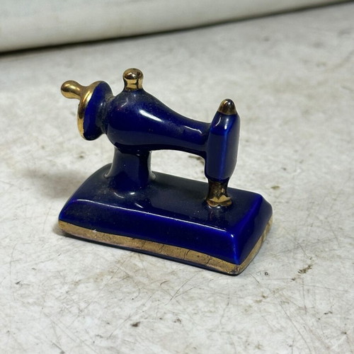 Vintage porcelain miniature sewing machine with gold details, used