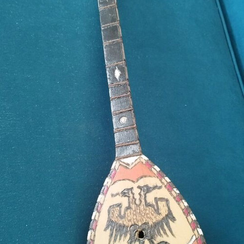 Çifteli used Albanian traditional musical instrument with decorative double-headed eagle