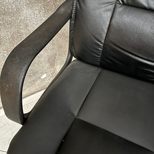 Black executive office chair with armrests and wheels