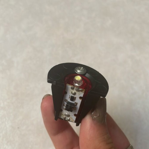 Small battery-operated LED light with cap