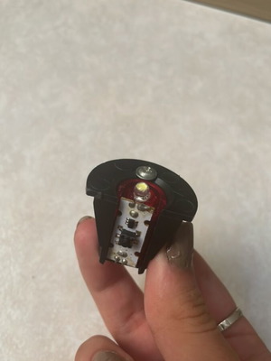 Small battery-operated LED light with cap