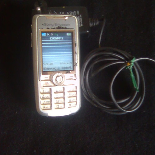 Sony Ericsson K700i used mobile phone with charger and headphones