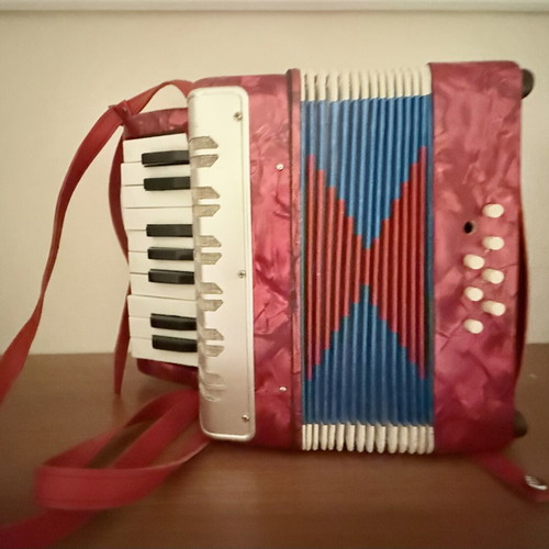 Children's accordion used, red with blue and red bellows