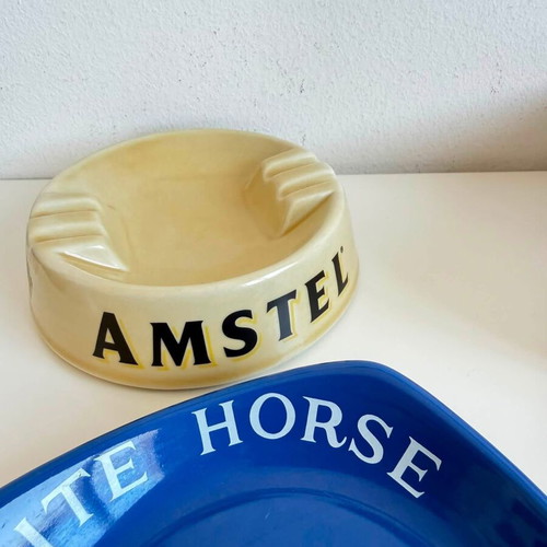 Set of 2 collectible porcelain ashtrays, Amstel and White Horse