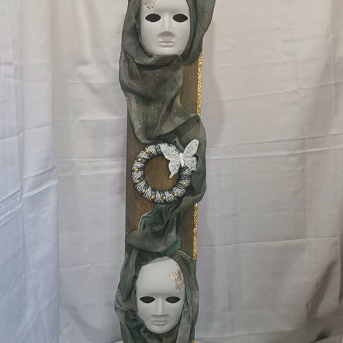Handmade wall decor with artistic masks and elegant fabric details