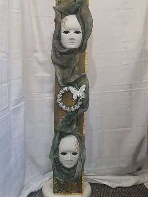 Handmade wall decor with artistic masks and elegant fabric details