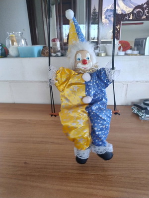 Ceramic clown harlequin acrobat doll on swing like new