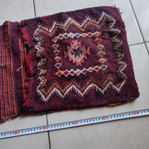 Old woven double horse saddle bag used with fabric tears