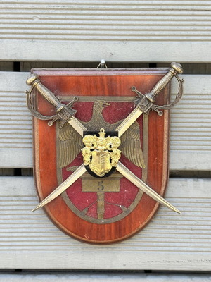 Military crest with crossed swords and eagle on wooden base used
