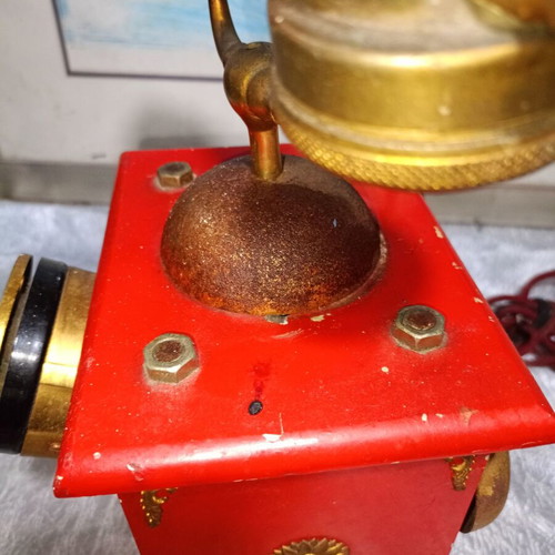 Vintage metal rotary phone, red with gold details