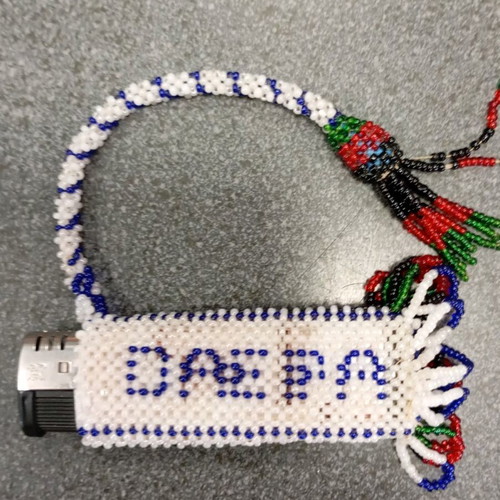 Beaded knitted case used, possibly for lighter or perfume bottle