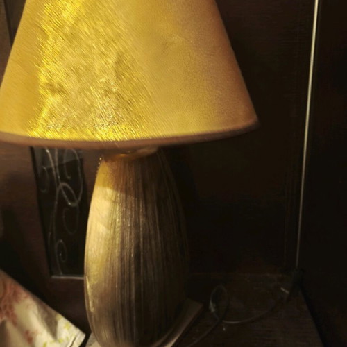 Table lamp used with switch in golden shade