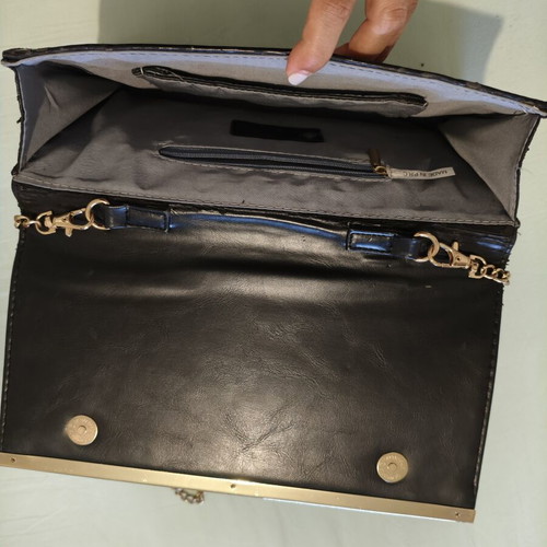 Black clutch bag with gold chain used, synthetic leather